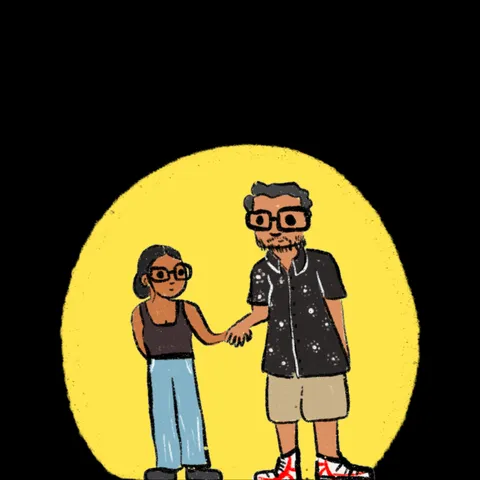 Two people in glasses holding hands, one in a vest and wide jeans, the other in a patterned shirt, shorts and red-laced sneakers, in a yellow spotlight on black.